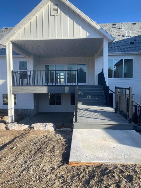Covered composite deck with stairs and a sloped approach