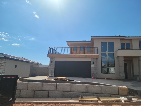 Modern home exterior with coordinated retaining and site improvements